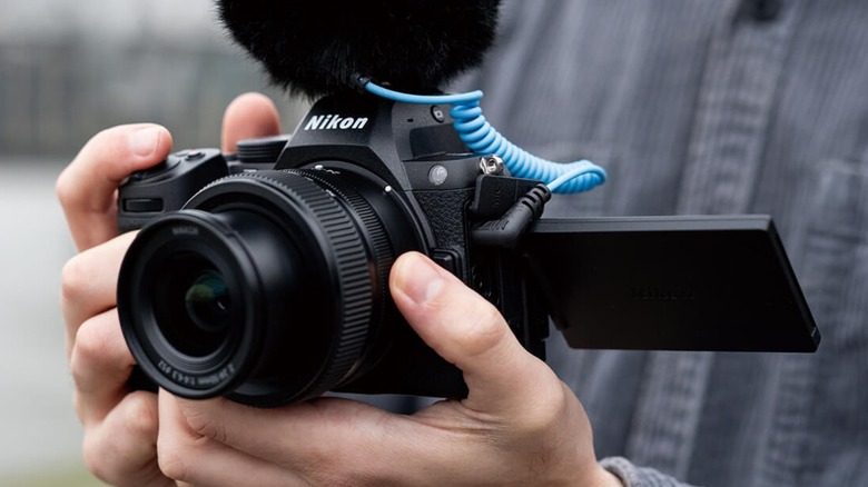 A person using a Nikon Z5II for shooting a video