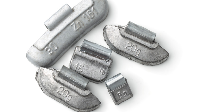 Close-up shot of assorted wheel weights on blank white background