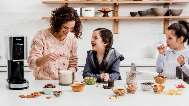 A family making ice cream with Ninja CREAMi