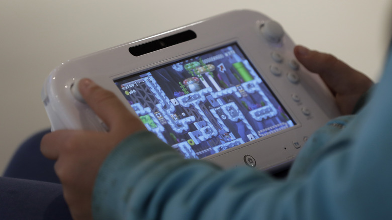 Gamer playing Wii U handheld