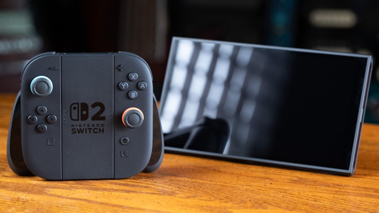 The Nintendo Switch 2 next to a controller on a table top.