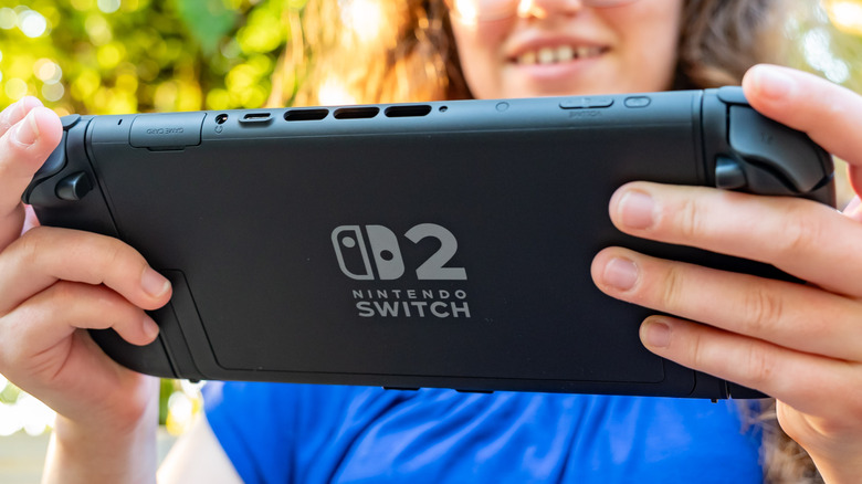 The Nintendo Switch 2 held in the hands of a person.