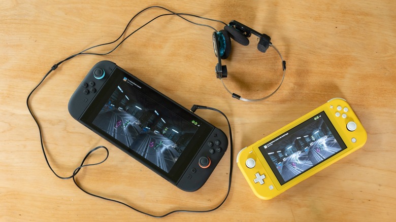 The Nintendo Switch 2 and Switch Lite playing Split Fiction with connected headphones on a table.