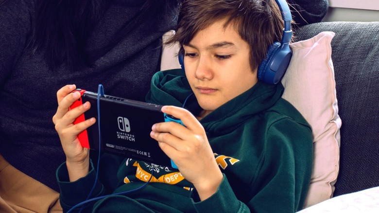 Young person plays Nintendo Switch