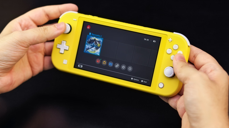 Hands holding Nintendo Switch Lite 