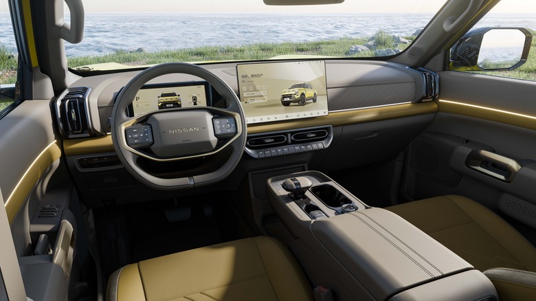 The interior of a Nissan Frontier Pro, with a body of water visible through the windshield.