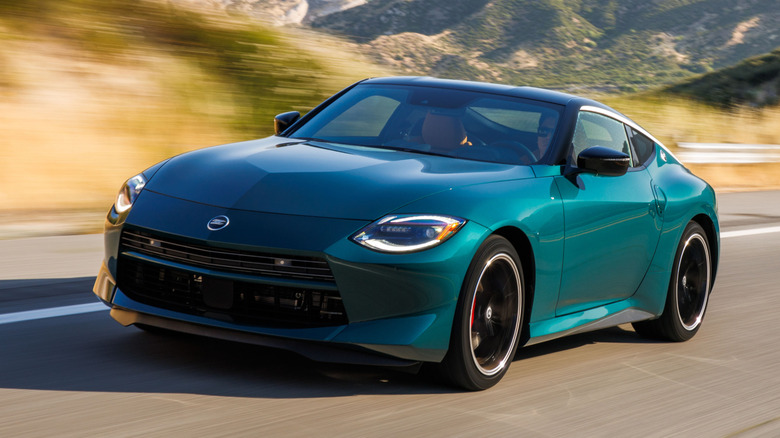 2027 Nissan Z Performance in the mountains, front 3/4 view, green exterior