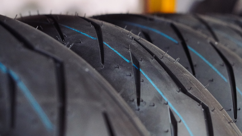 A stack of brand new motorcycle tires at a motorbike service center