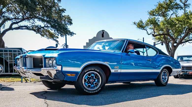 Low perspective front corner view of a 1972 Oldsmobile 442 W30 Hardtop Coupe at a lcar show.