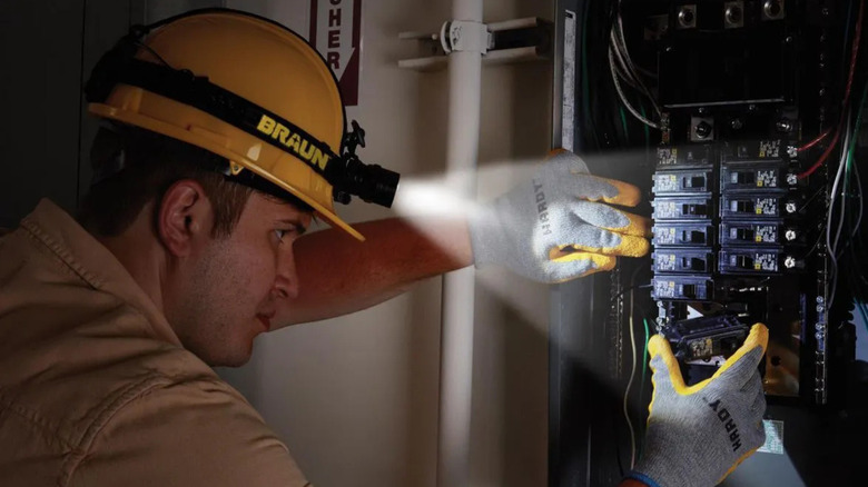 A worker using the Braun 500 Lumen Professional Swivel Headlamp