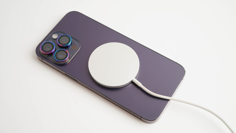 iPhone with MagSafe charger attached