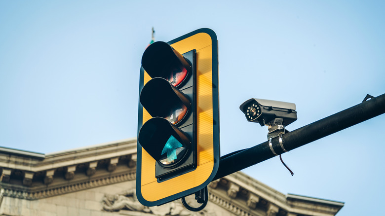 Camera perched next to traffic light