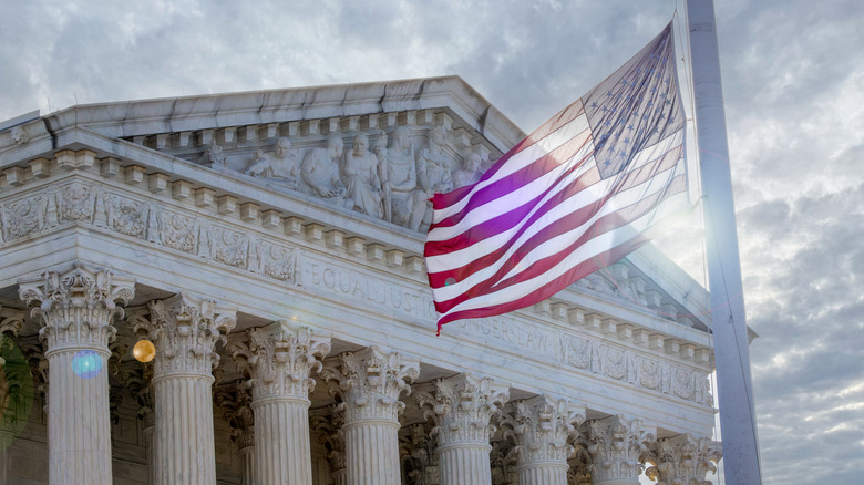 Supreme Court building with American flag waving