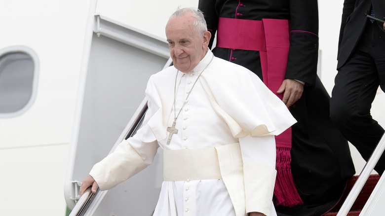 Pope Francis disembarking an airplane.
