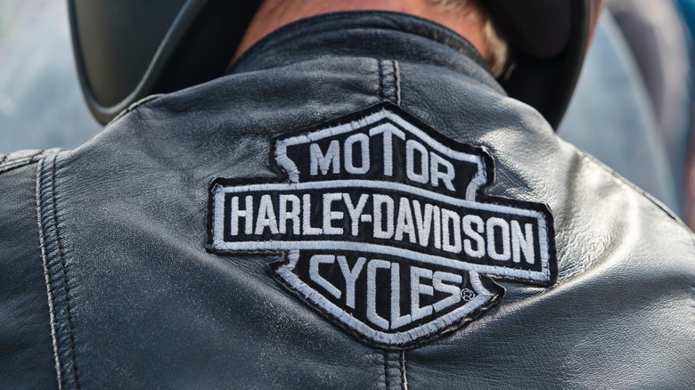 The Harley-Davidson logo embroidered on the back of biker's jacket