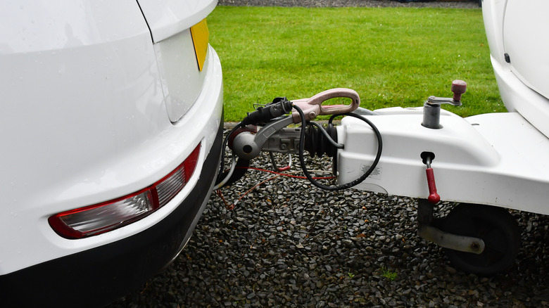 car attached to a trailer by a tow bar