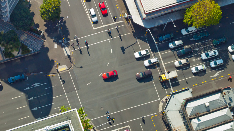 An overhead view of a busy four-way intersection with multiple lanes