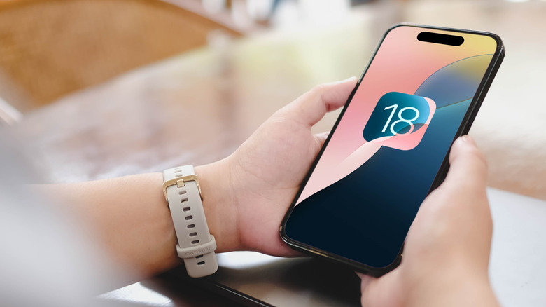 iOS 18 logo on iPhone screen