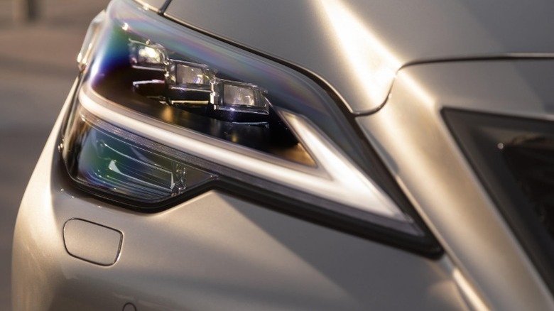 Close-up of the front-right headlamp on a silver Lexus LS