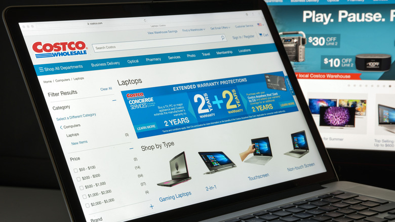 Costco webpage on a laptop screen showing different laptops available for purchase