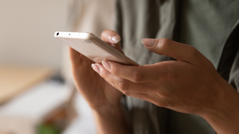 close-up of a woman's hands holding a smartphone
