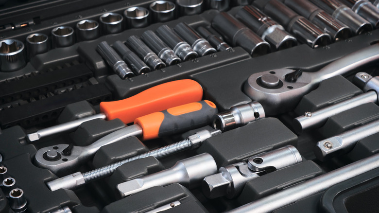 Close-up of tools and sockets in a toolbox.