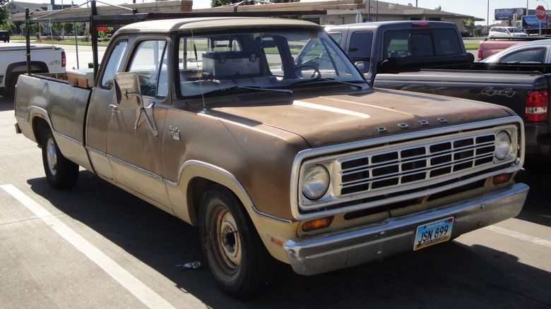 A brown over tan Dodge D-100 Club Cab pickup truck.