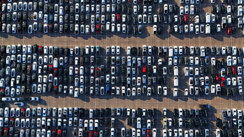 Top-down view of a parking lot filled with new cars