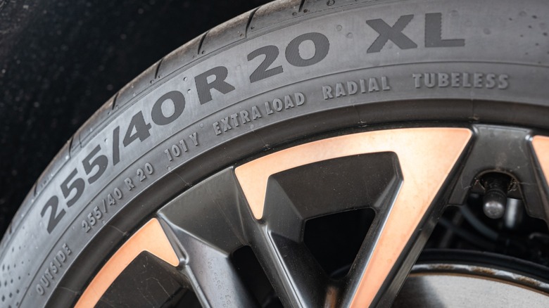 A car tire with all of the size information printed on the side.