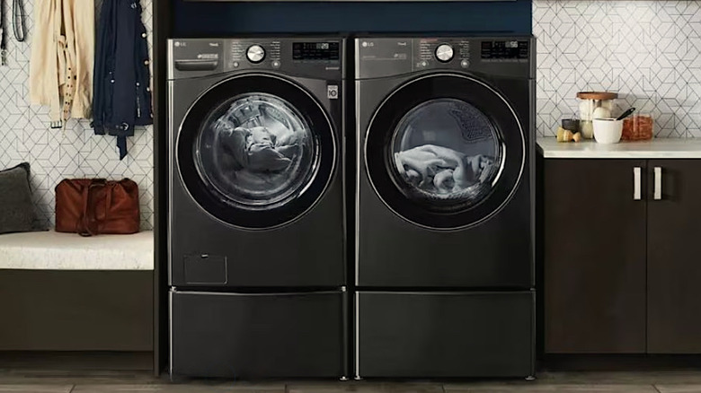 LG washer and gas dryer displayed side by side in a modern kitchen