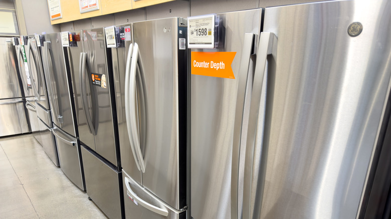 3-Door stainless steel refrigerators on display inside a Home Depot store