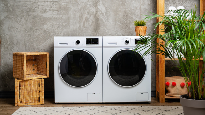 Two front load washers in a room