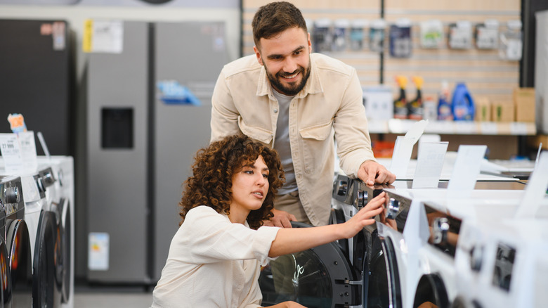 Man and woman shopping for home appliances