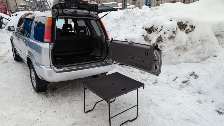 Honda CR-V with an open cargo area and a picnic table next to it