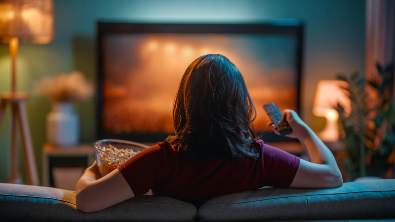 Woman watching a movie on TV