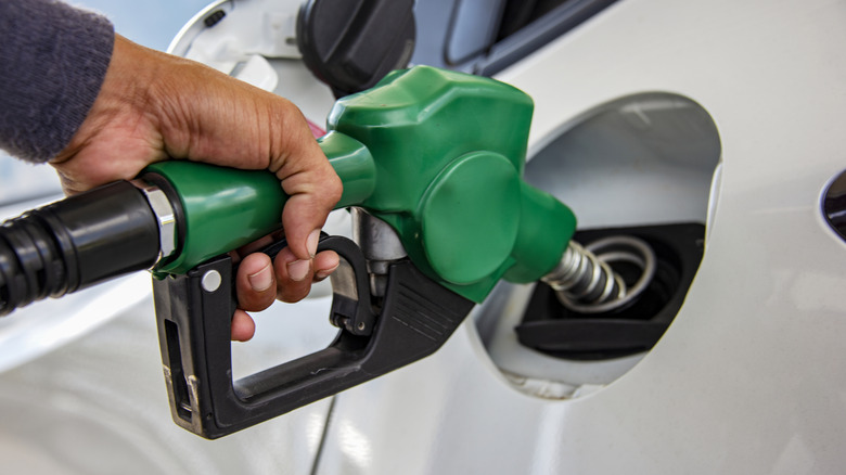 Driver refueling with green handle diesel fuel pump