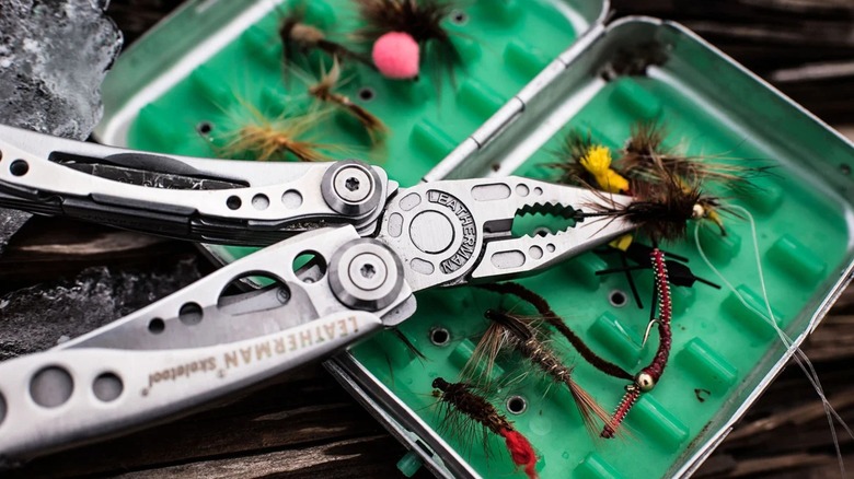 Leatherman Skeletool on top of a fishing fly box