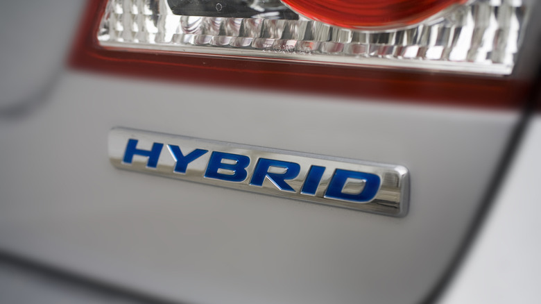 Close-up view of a hybrid nameplate on the rear of a vehicle