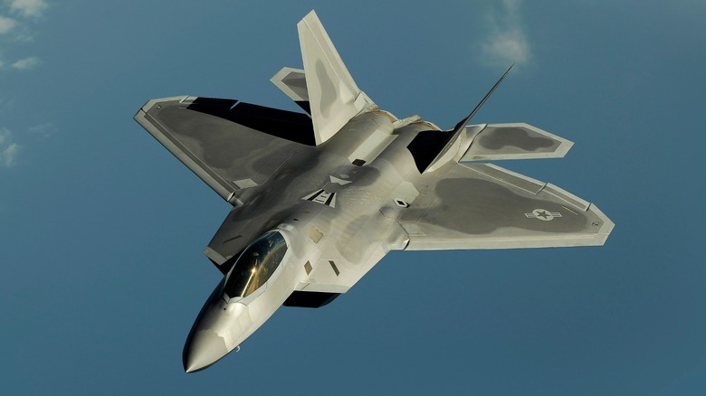 An F-22 Raptor flying over the ocean
