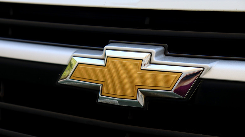 A close-up of the Chevrolet logo on a silver vehicle grille