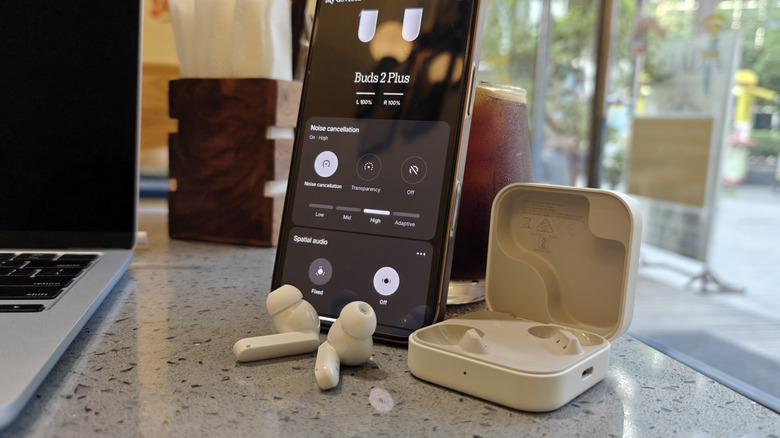 Nothing CMF Buds 2 Plus earbuds and iPhone.