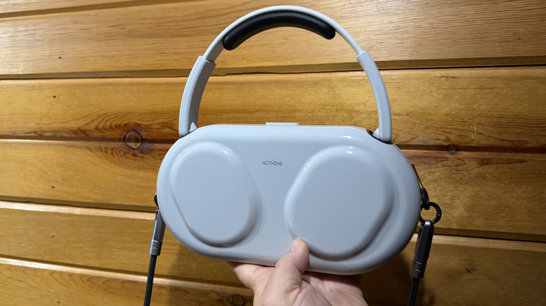 Man holding the Nothing Headphone (1) Pro in their case