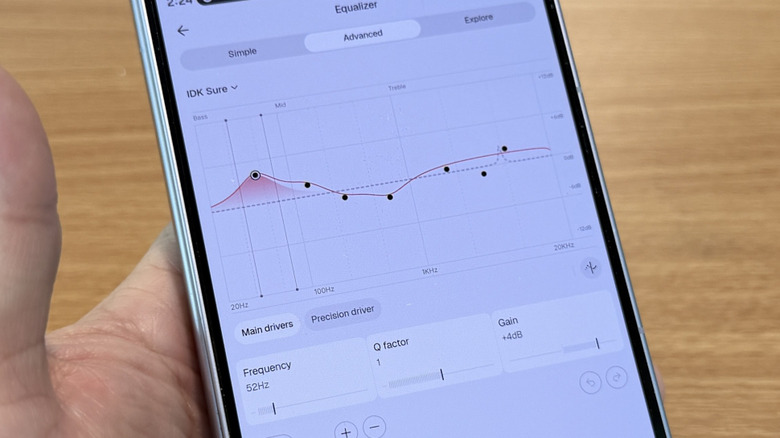 Hand holding a phone with equalizer settings