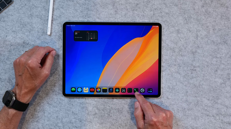Man pointing his finger at the Phone app on an iPad