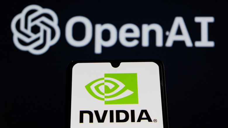 A phone with NVIDIA logo in front OpenAI's logo