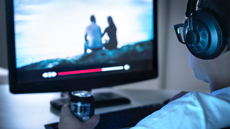 Person watching video on PC monitor