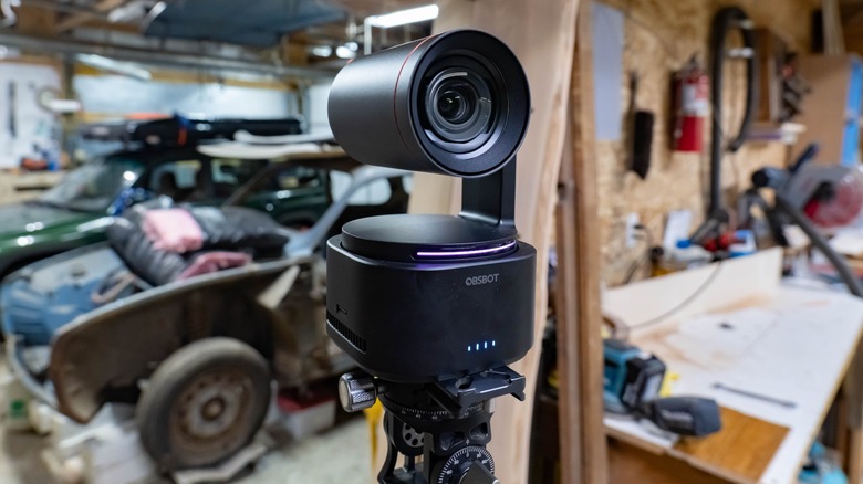 Filming with the Obsbot Tail 2 in a shop with tools and old cars.