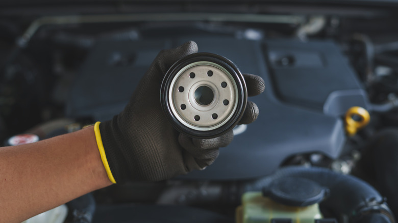 Mechanic holding oil filter