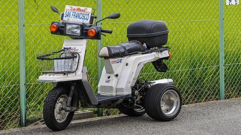 Honda Gyro near a fence