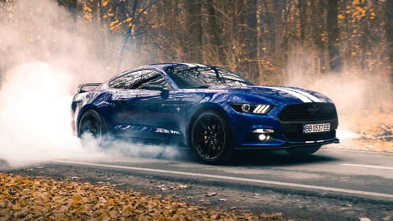 Blue Ford Mustang burning out
